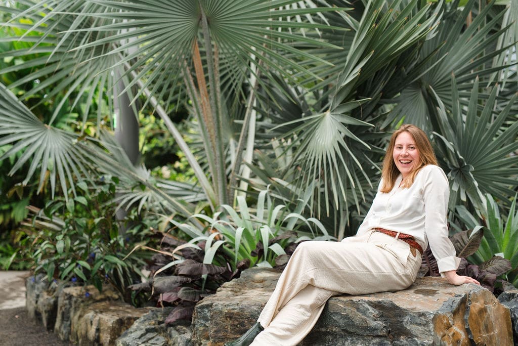 Jenna Harding Sitting on a Bench Smiling at the Camera