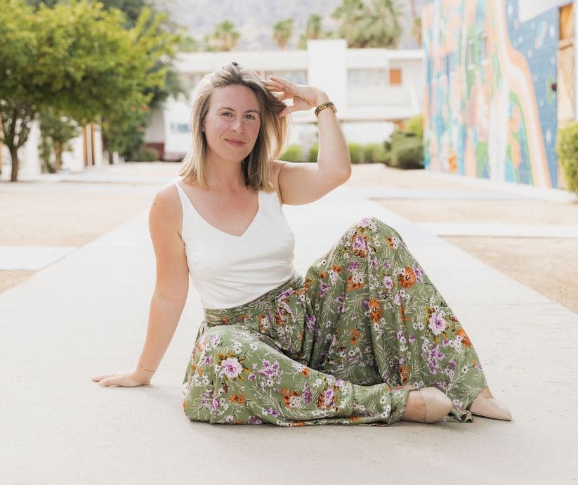 Picture of Jenna Harding Sitting on the Floor Smiling at the Camera | Cover Image for Local Marketing Strategies Blog Post